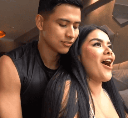 She is stopping him but he isn't